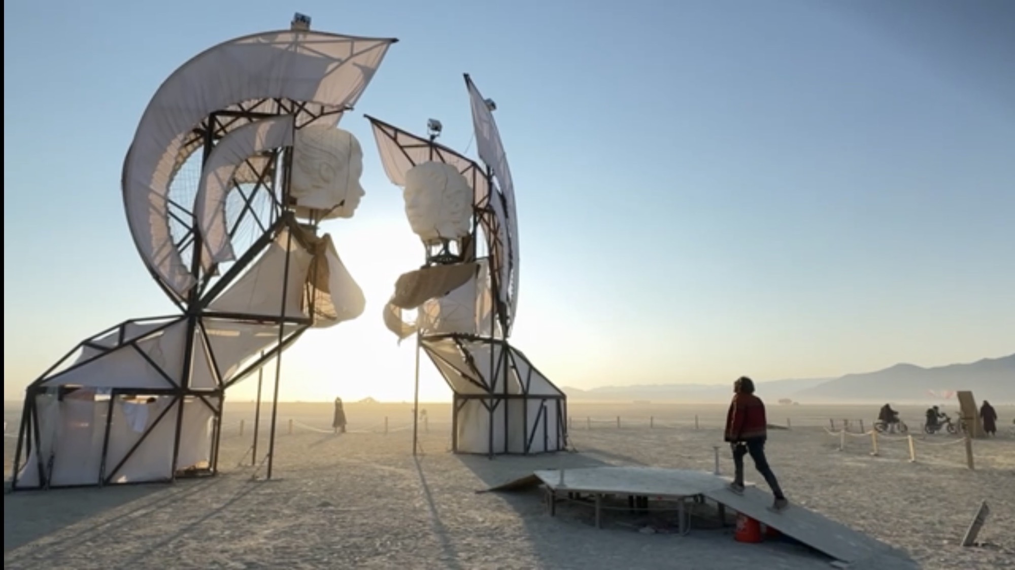A seeker approaches the Sphinx Gate at sunset, Burning Man 2025